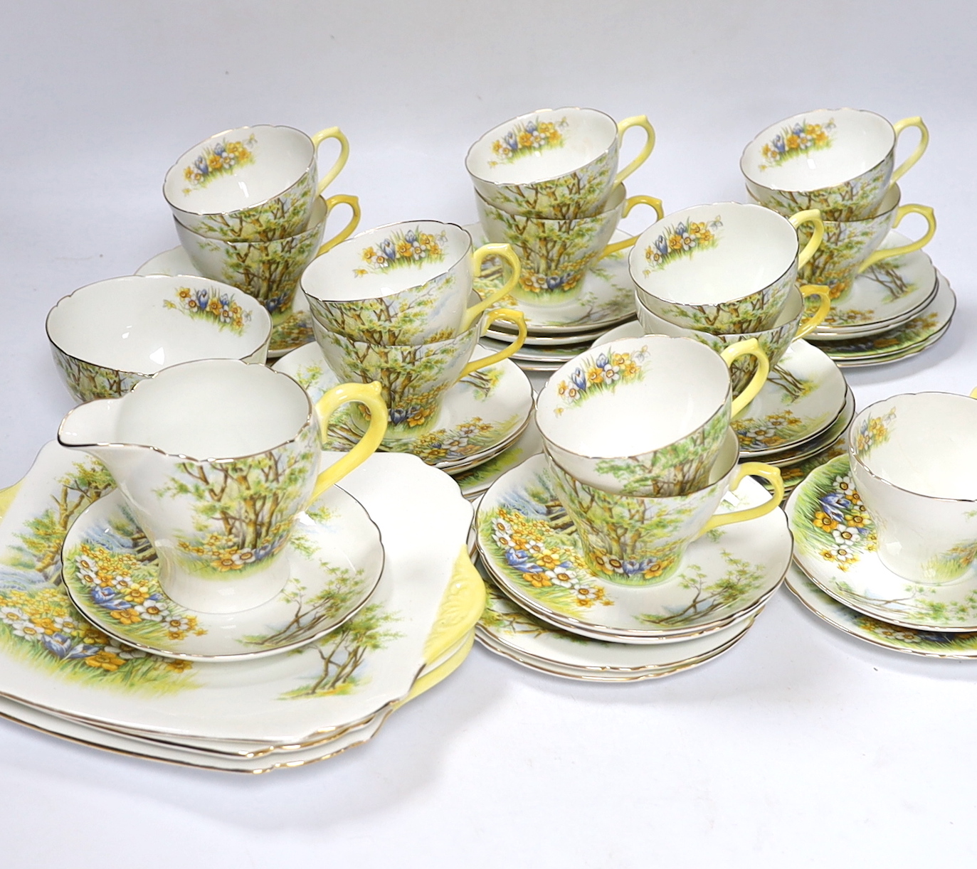 A Shelley ‘Daffodil Time’ pattern tea set with thirteen trios, three sandwich plates, milk jug and bowl, largest 24cm wide